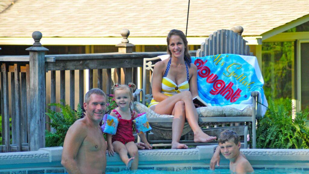 Family Sitting on Above Ground Pool Deck