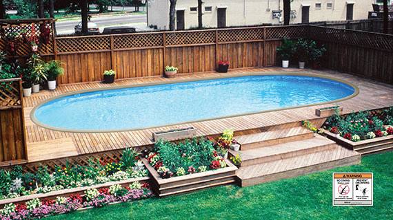 A Doughboy pool installed to look like an in-ground pool surrounded by a deck.