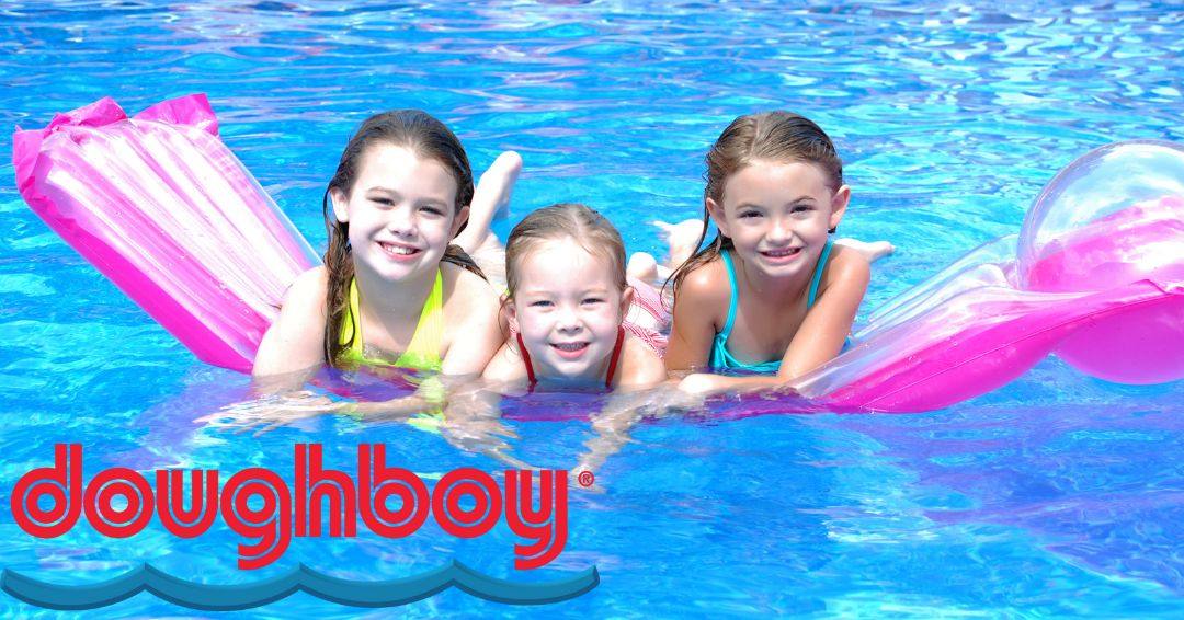 Three girls are resting on a float in a Doughboy Pool.