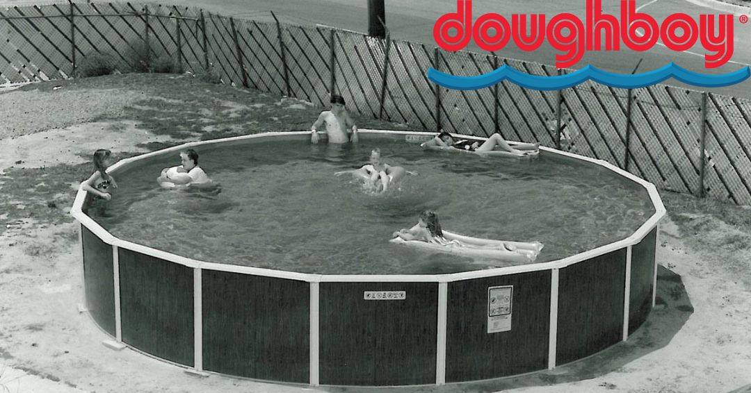 A black and white image of an old Doughboy Pool. There are kids playing in the water.