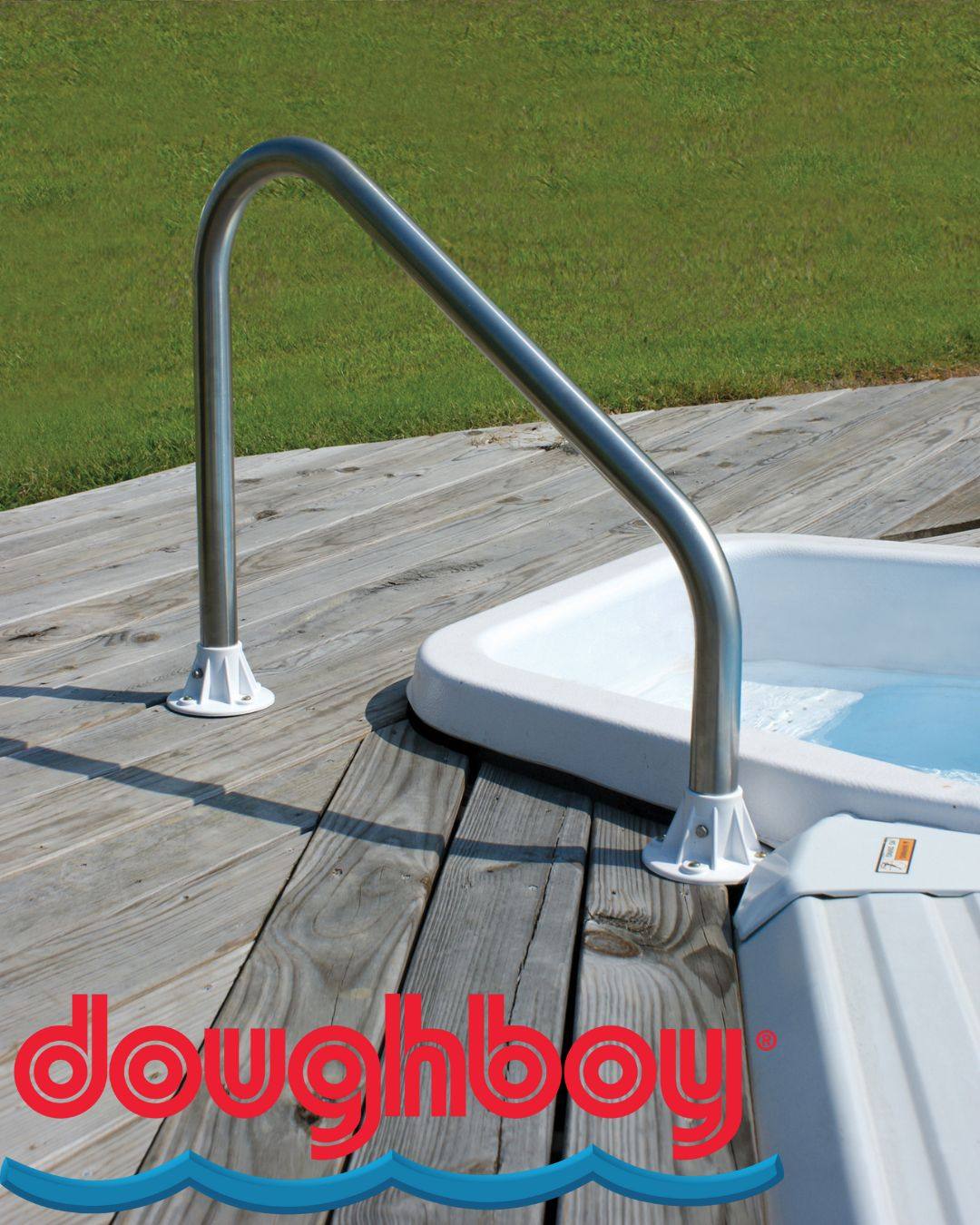 A metal handrail on the deck of an inset above ground pool.